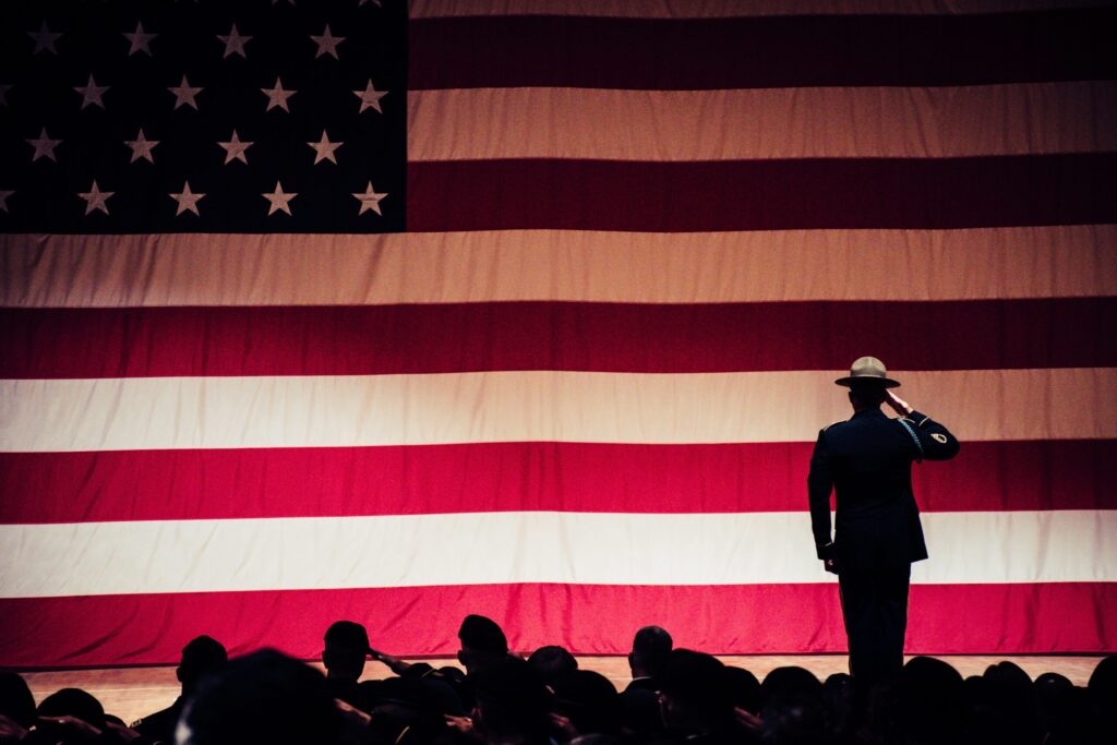 Soldiers saluting American flag