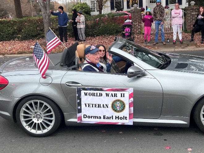 World War II veteran riding in a car in Veterans Day Parade